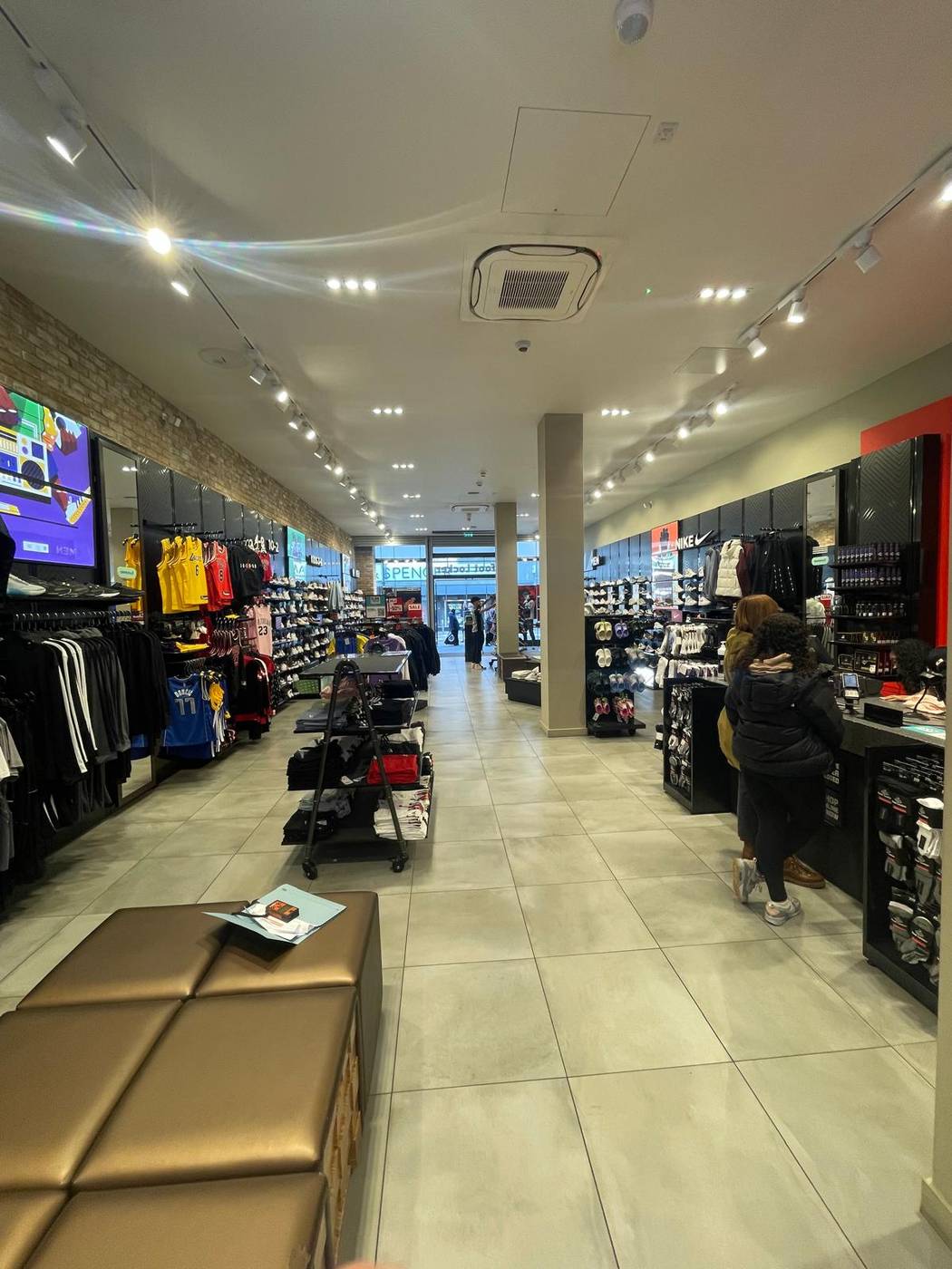 Completed retail store interior with finished bulkhead ceiling and lighting