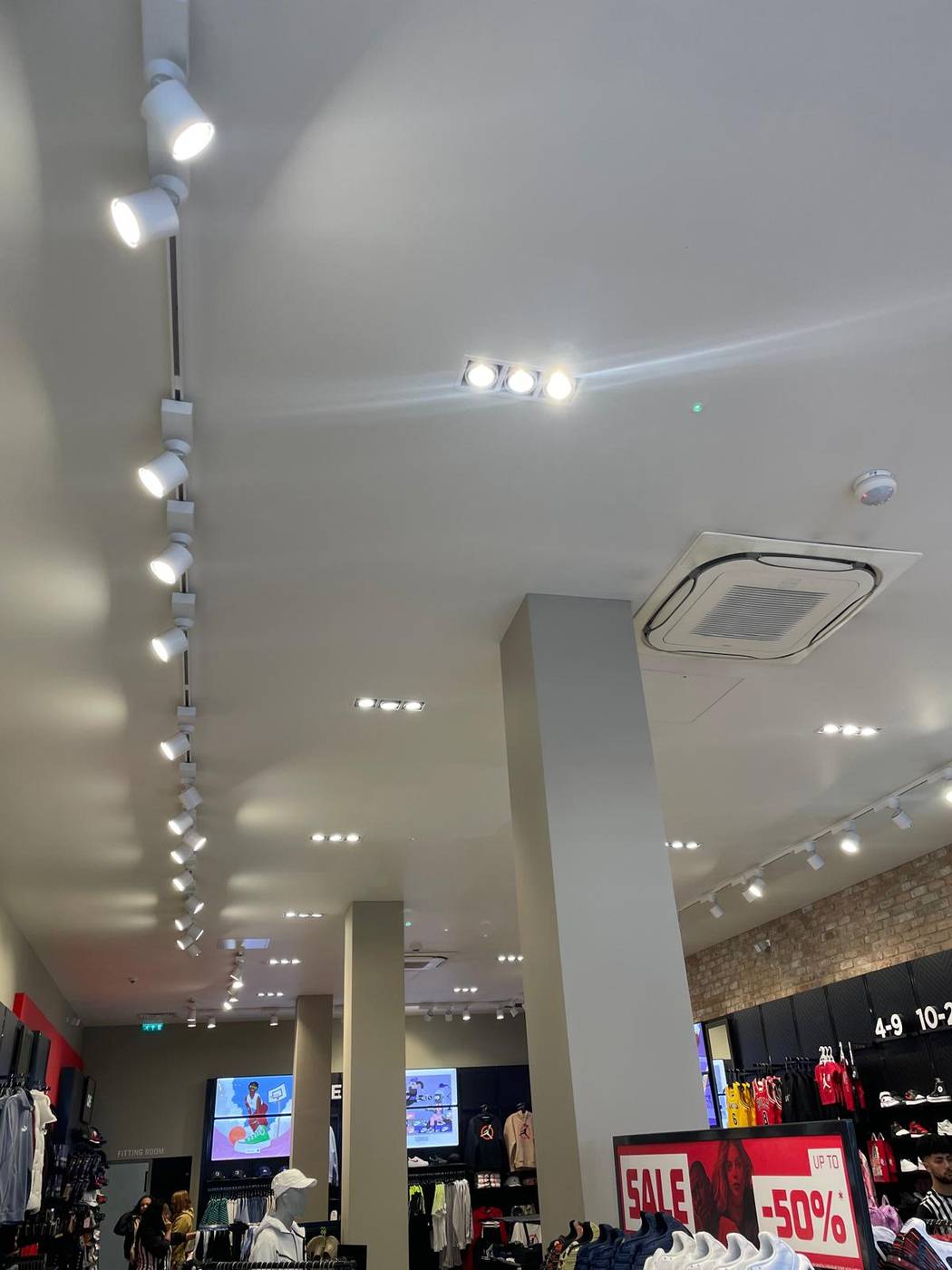 Finished white retail ceiling with track and feature lighting