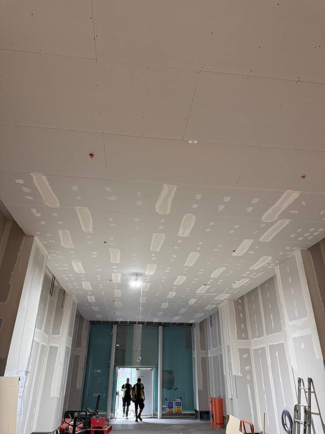 Large hall with boarded and jointed plasterboard ceiling