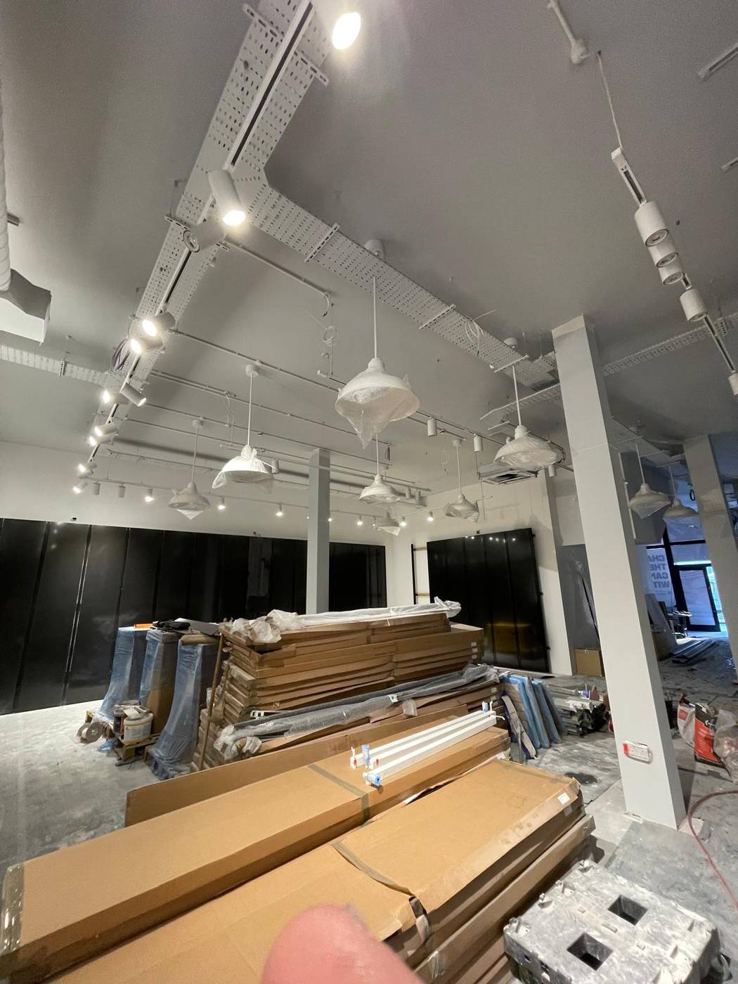Retail fit-out with exposed services ceiling and feature pendant lights