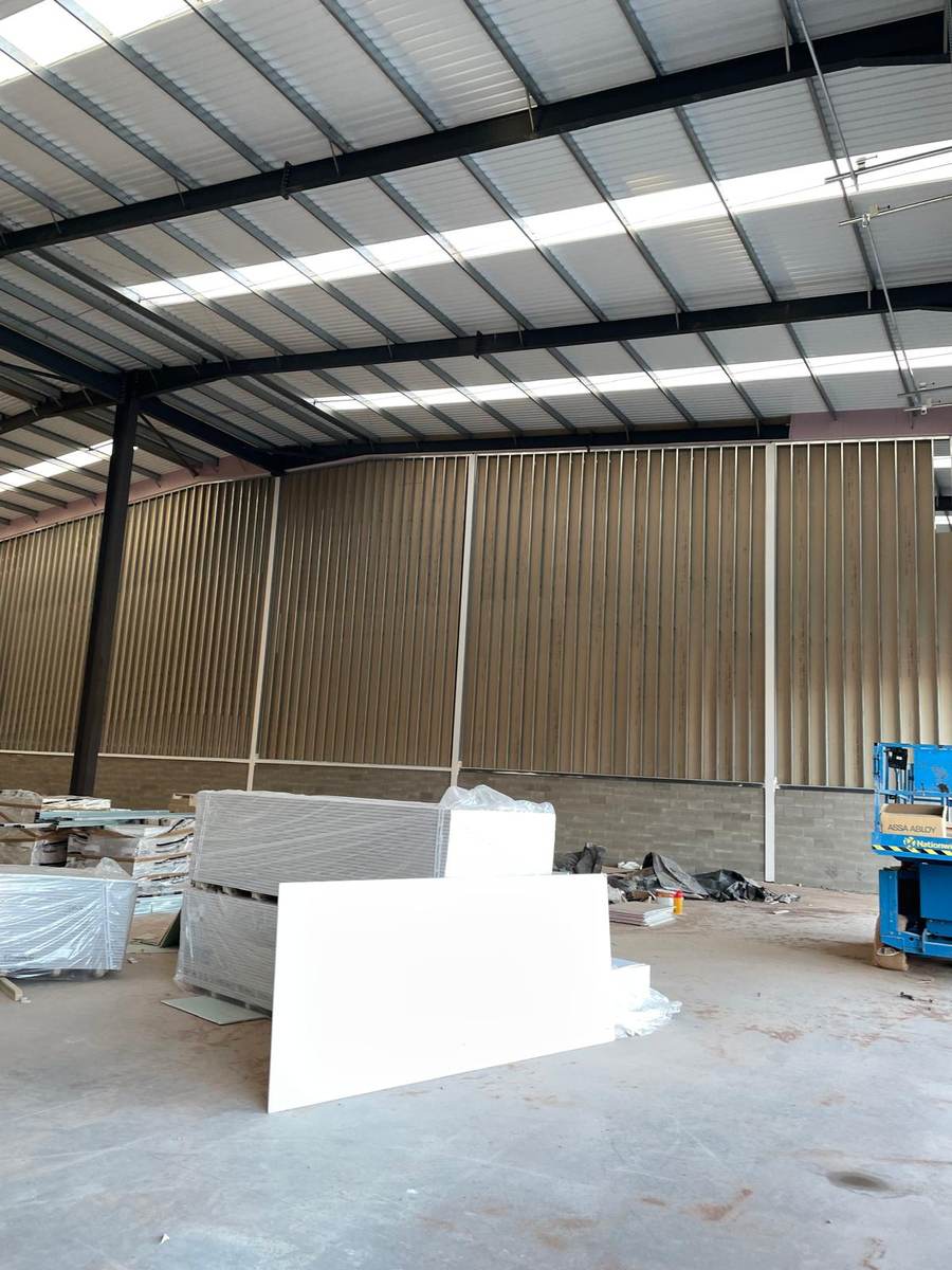 Industrial warehouse unit with insulated lining and stacked plasterboard