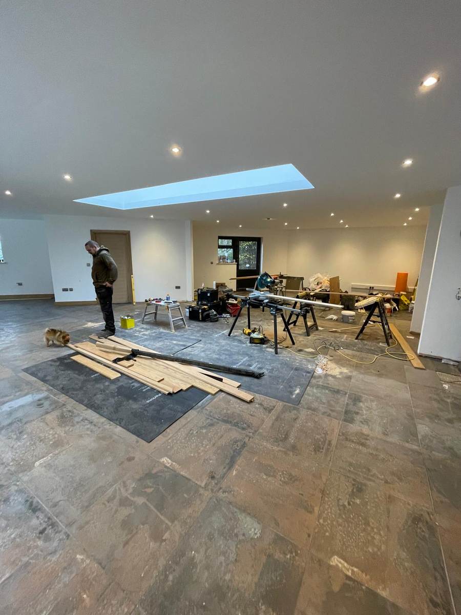 Large open-plan room with smooth plastered ceiling and skylight reveal