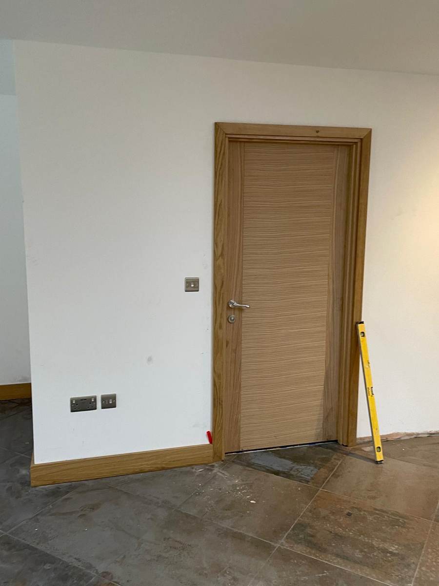 Smooth plastered walls with oak door and skirting