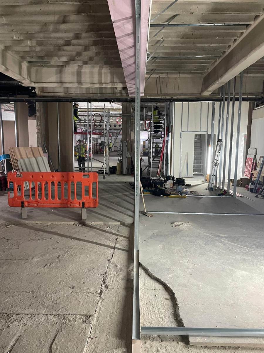 Commercial fit-out with metal stud partitions under a concrete soffit