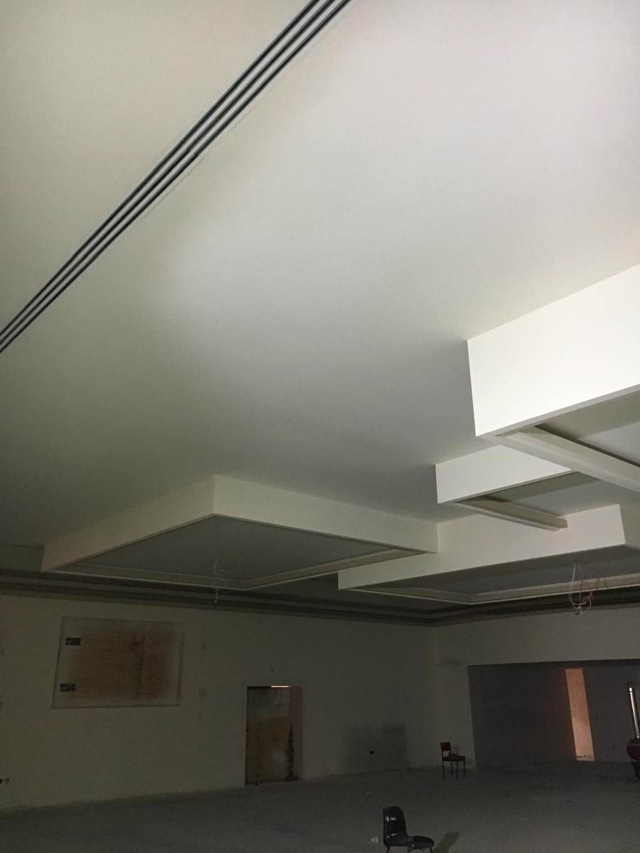 Large room with stepped feature plasterboard ceiling and bulkheads