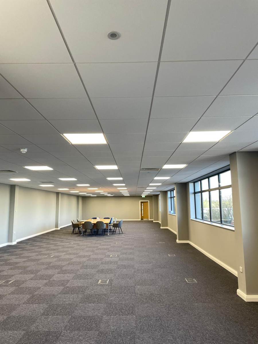 Completed meeting room with suspended ceiling and carpet