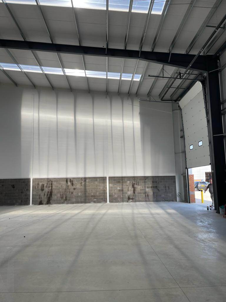 Industrial unit interior with finished lined walls and loading door