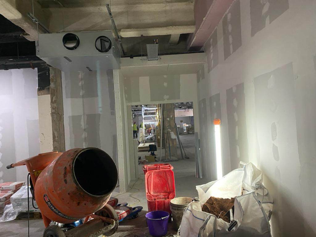 Drylined and taped commercial corridor during fit-out