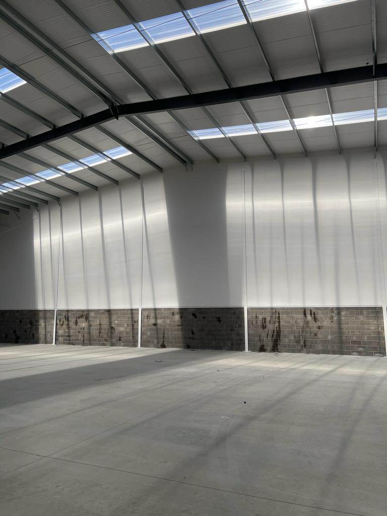 Industrial unit with finished white lined walls and rooflights