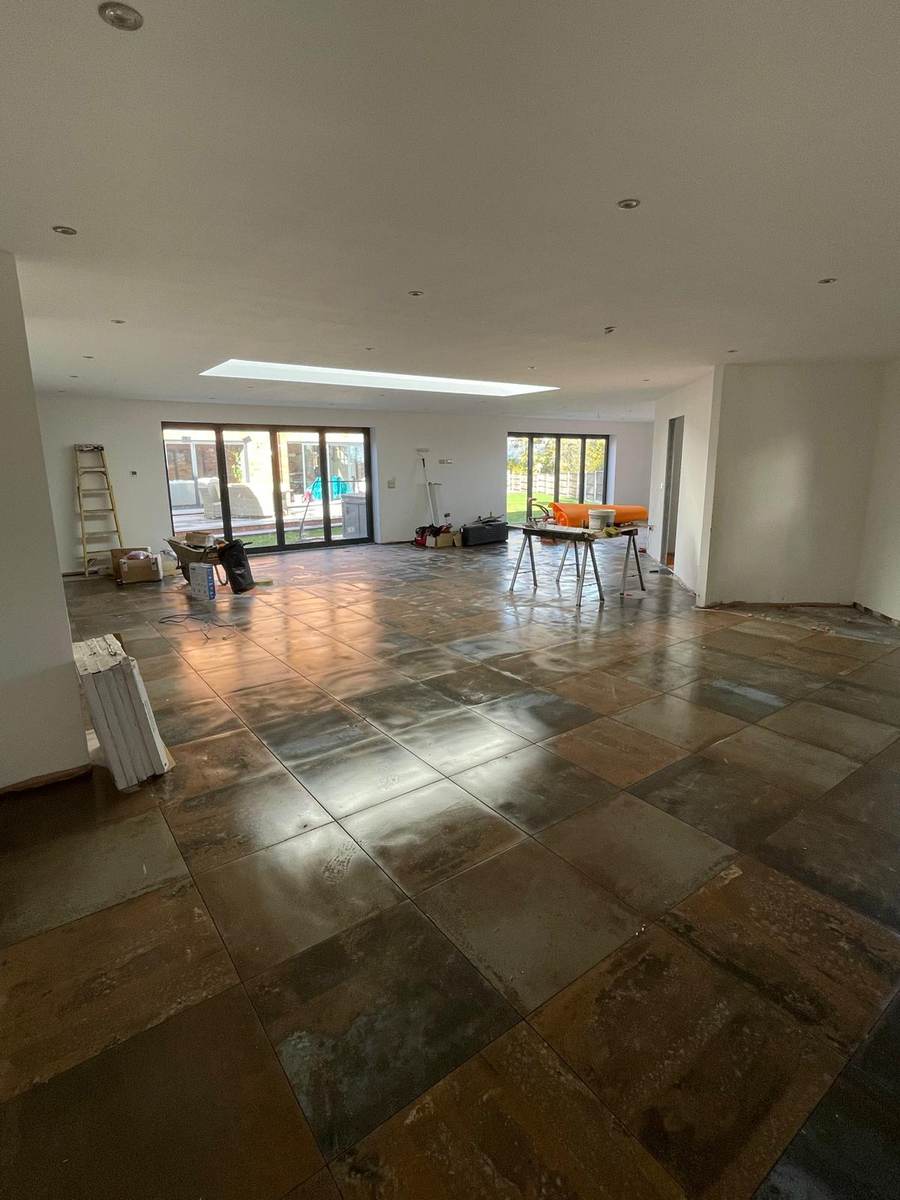 Large open-plan space with plastered ceilings and bi-fold doors